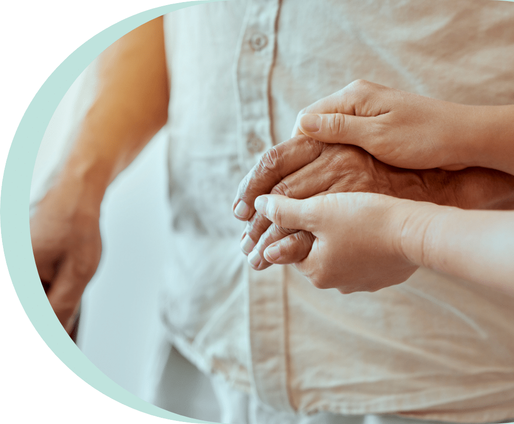 closeup of a woman holding the hands of an older man who has osteoporosis in seniors