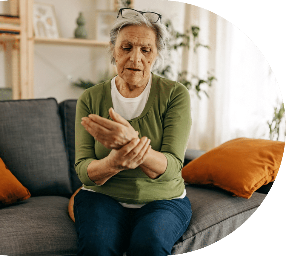 elder woman holder her wrist while suffering from symptoms of osteoporosis in seniors
