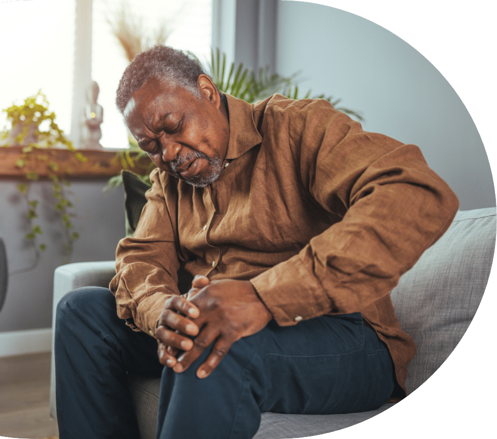 elder man sitting and holding his knee while feeling pain for senior osteoporosis