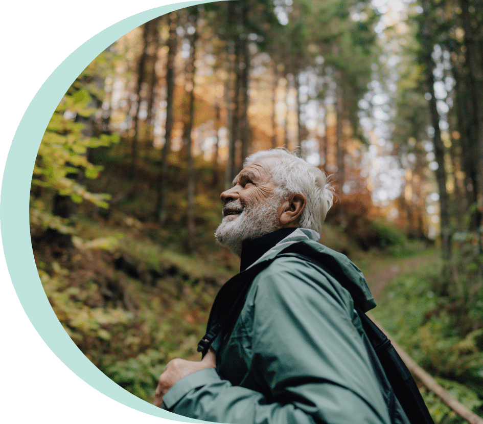 Older adult man hiking outside after senior fall prevention