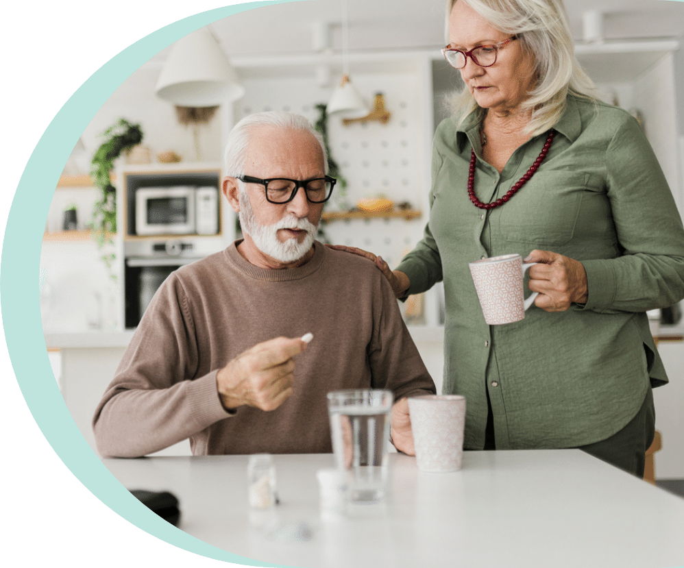 Senior couple sit at the counter in the kitchen as they look at side effects of furosemide