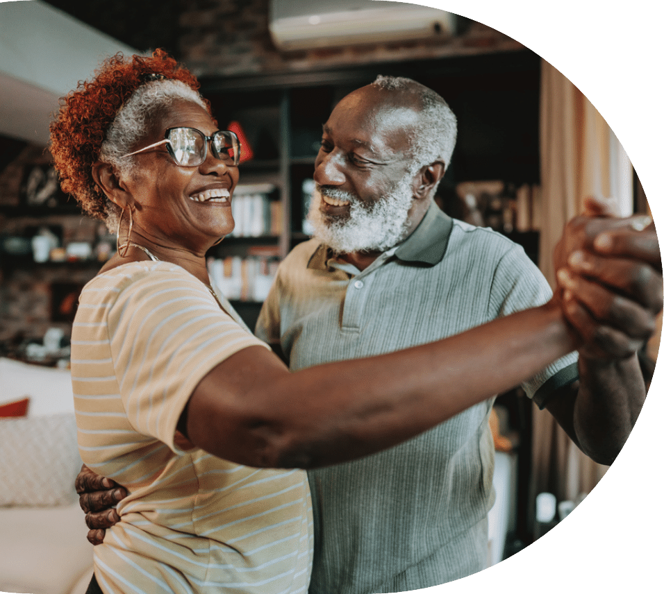 Senior couple dancing in the kitchen while feeling better after taking amlodipine