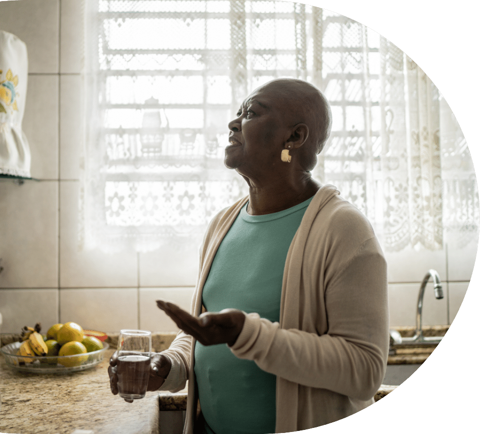Senior woman taking prescription aspirin in her kitchen
