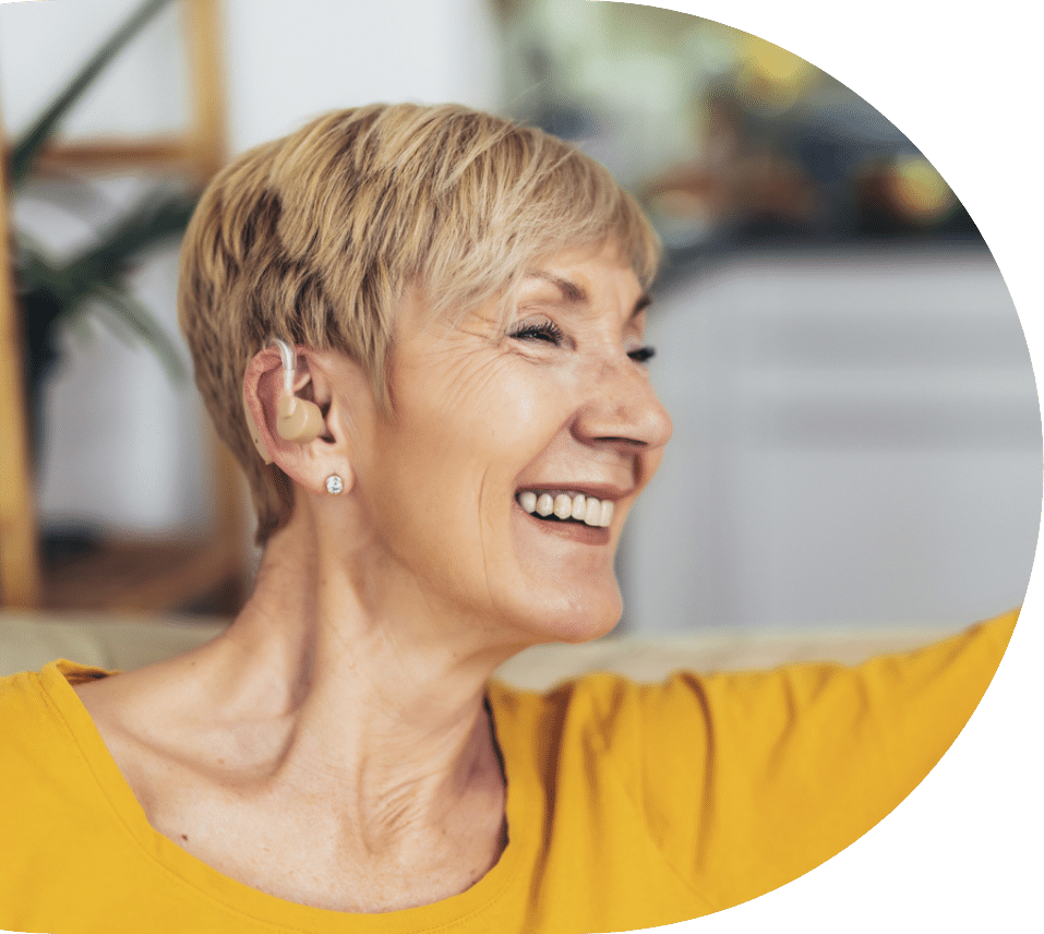 Smiling woman with hearing aid