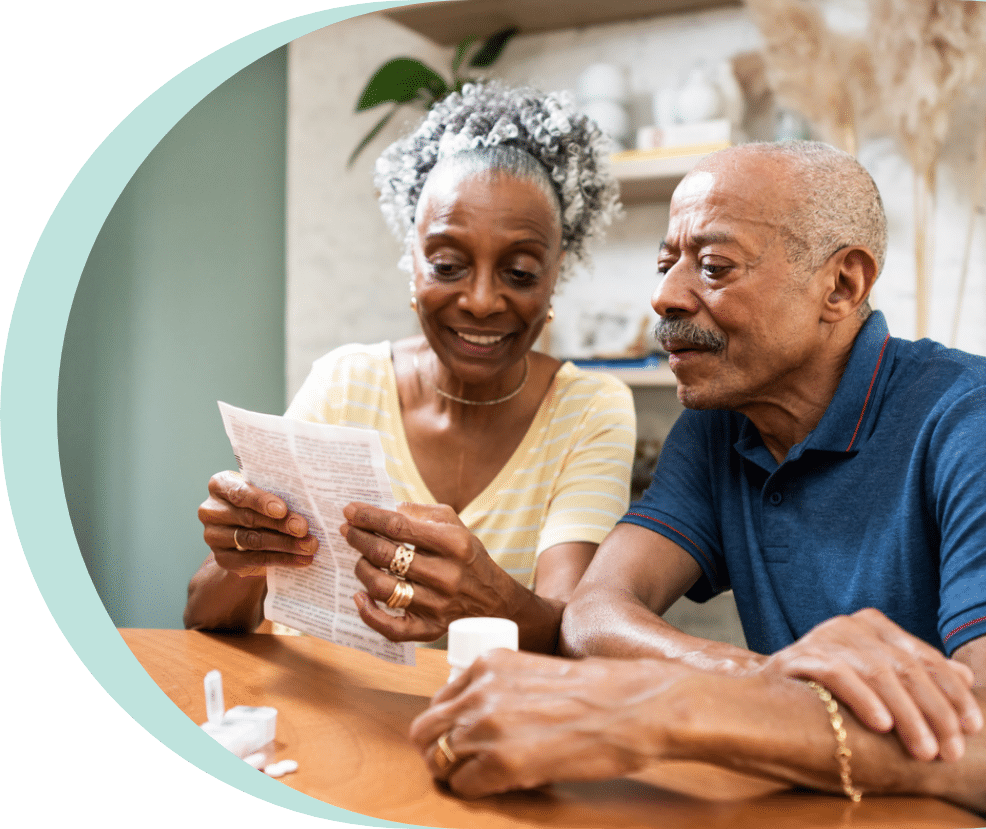 Older couple sitting in the kitchen while reading through gabapentin side effects