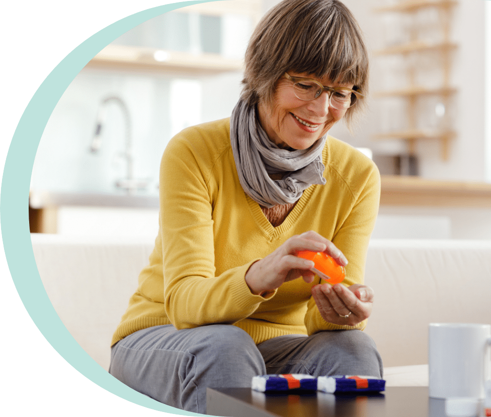 Older woman looking at her bottle for hydrochlorothiazide side effects